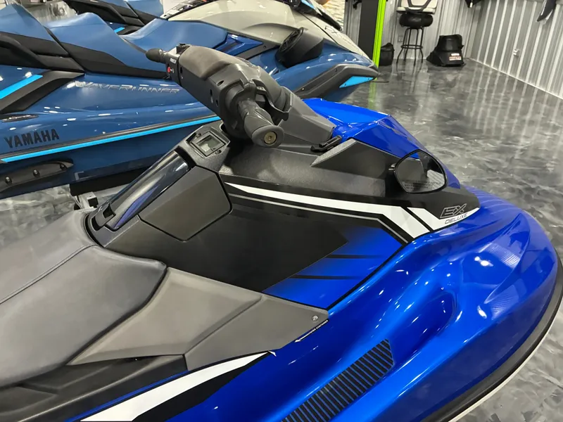 Slide: The Image of A blue 2018 Yamaha EX Deluxe jet ski is displayed in a showroom. - 5