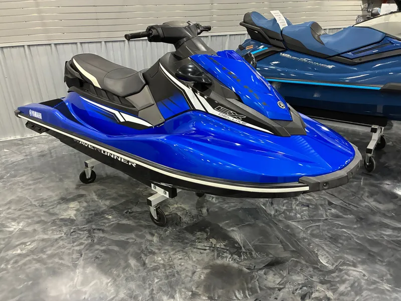 The Image of A blue 2018 Yamaha EX Deluxe jet ski is displayed on a showroom floor. - 1