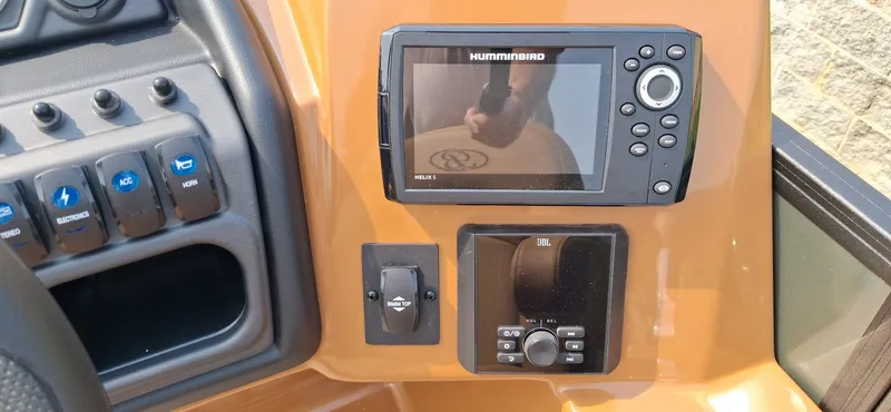 Slide: The Image of The image shows a boat cockpit with a Humminbird display and various control buttons. - 4