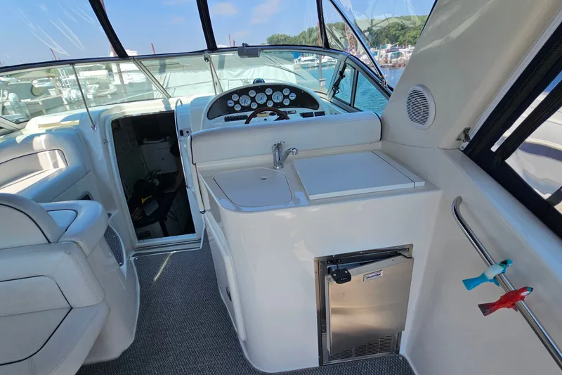 Slide: The Image of 2001 Mustang 3200 Sport Cruiser interior with helm, sink, and mini-fridge. - 8
