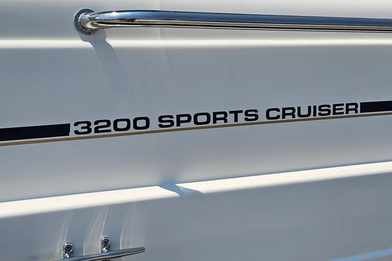 Slide: The Image of 2001 Mustang 3200 Sport Cruiser boat side view with model name displayed. - 24