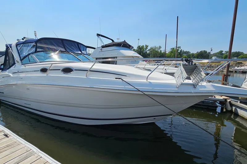 Slide: The Image of 2001 Mustang 3200 Sport Cruiser docked at marina under clear blue sky. - 3