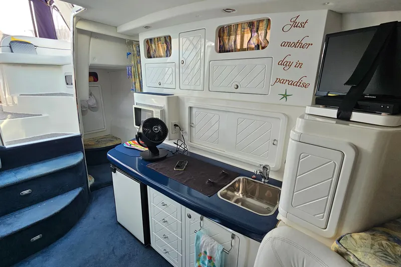 Slide: The Image of Interior of a 2001 Mustang 3200 Sport Cruiser with kitchenette and cozy seating. - 18