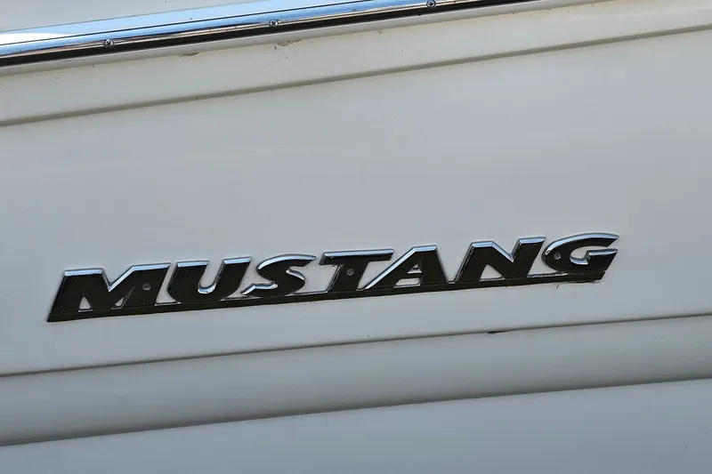 Slide: The Image of Mustang 3200 Sport Cruiser 2001 logo on white boat exterior. - 25