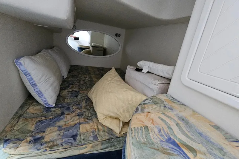Slide: The Image of Interior cabin of 2001 Mustang 3200 Sport Cruiser with cozy bedding and pillows. - 21