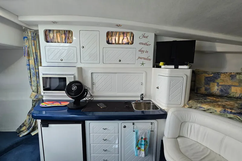 Slide: The Image of Interior of a 2001 Mustang 3200 Sport Cruiser with kitchenette and cozy seating. - 17