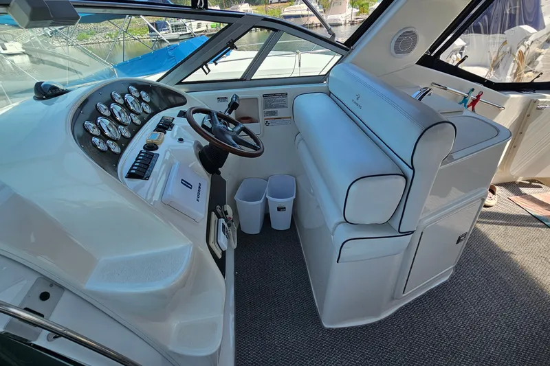 Slide: The Image of Interior of a 2001 Mustang 3200 Sport Cruiser boat with steering wheel and control panel. - 11