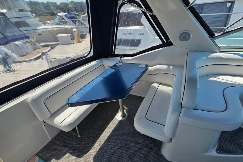 Slide: The Image of Interior of 2001 Mustang 3200 Sport Cruiser with blue table and white seating. - 6