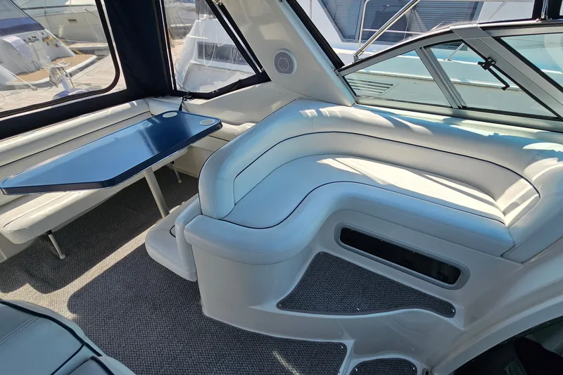 Slide: The Image of Interior of 2001 Mustang 3200 Sport Cruiser with white seating and blue table. - 9