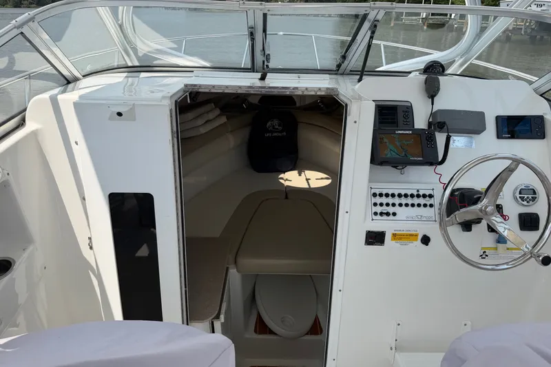 Slide: The Image of 2013 Sea Fox 256 Voyager boat cockpit with steering wheel and navigation equipment. - 28