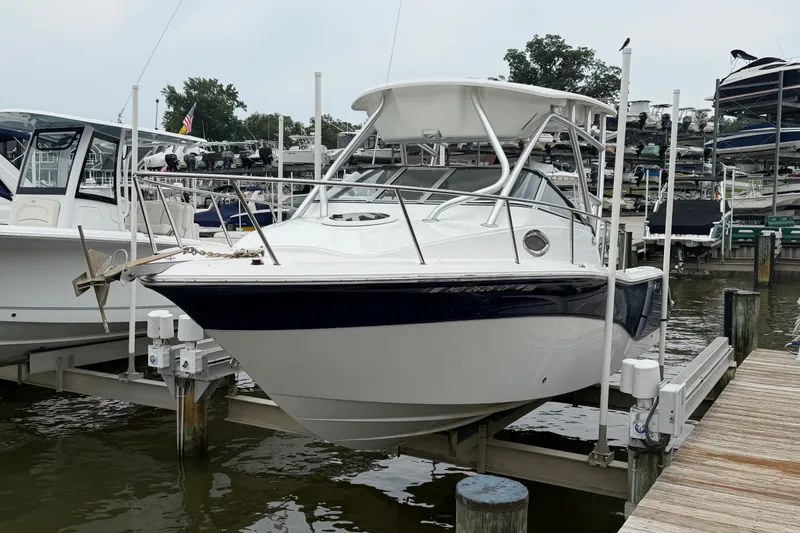 Slide: The Image of 2013 Sea Fox 256 Voyager boat docked at marina, featuring sleek design and sturdy build. - 5