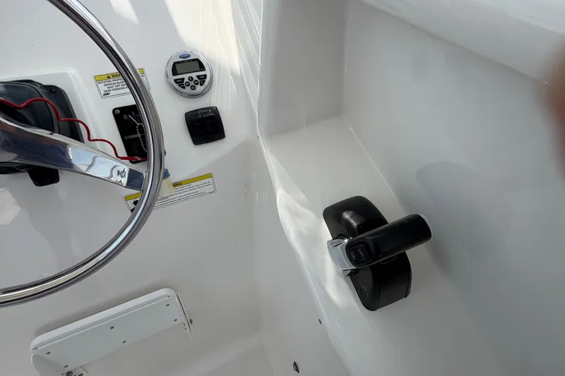 Slide: The Image of 2013 Sea Fox 256 Voyager helm with steering wheel and control panel. - 21