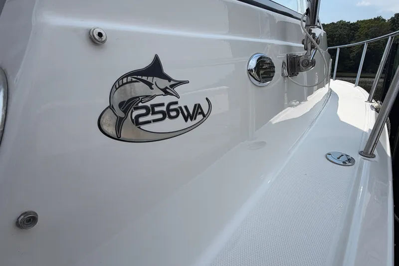 Slide: The Image of 2013 Sea Fox 256 Voyager boat with marlin logo on white hull. - 25