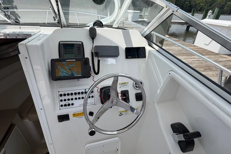 Slide: The Image of 2013 Sea Fox 256 Voyager helm with navigation equipment and steering wheel. - 17