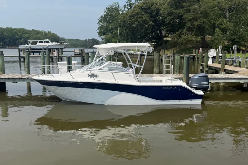 Slide: The Image of 2013 Sea Fox 256 Voyager boat docked on calm water with Yamaha engine. - 5