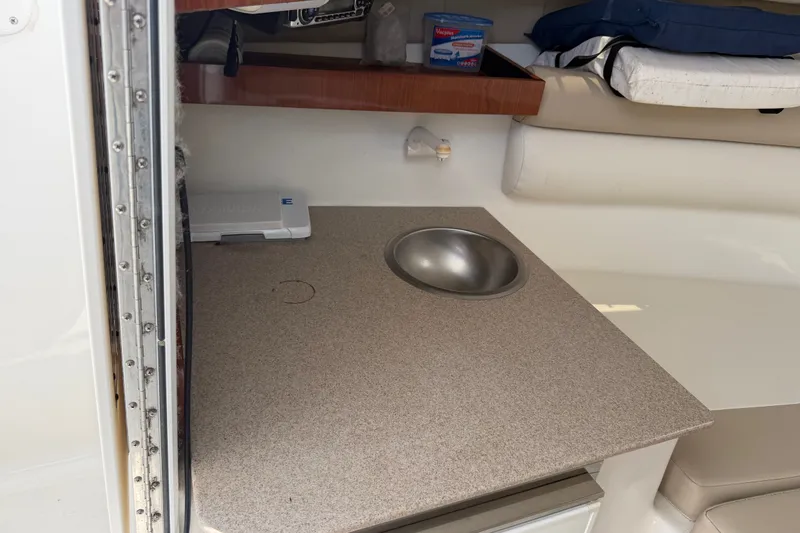 Slide: The Image of 2013 Sea Fox 256 Voyager cabin interior with sink and storage shelf. - 29