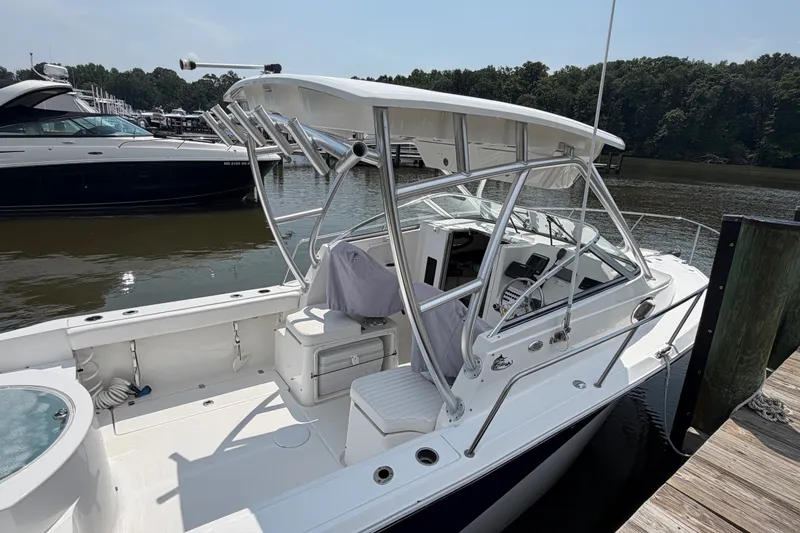 Slide: The Image of 2013 Sea Fox 256 Voyager boat docked, featuring spacious deck and modern design. - 14