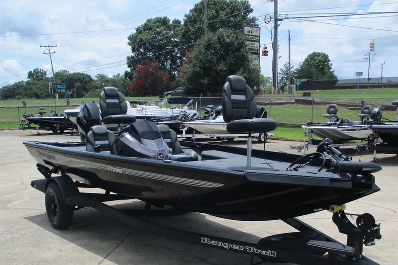 Slide: The Image of 2027 Ranger RT178 fishing boat on trailer, parked outdoors under a cloudy sky. - 9