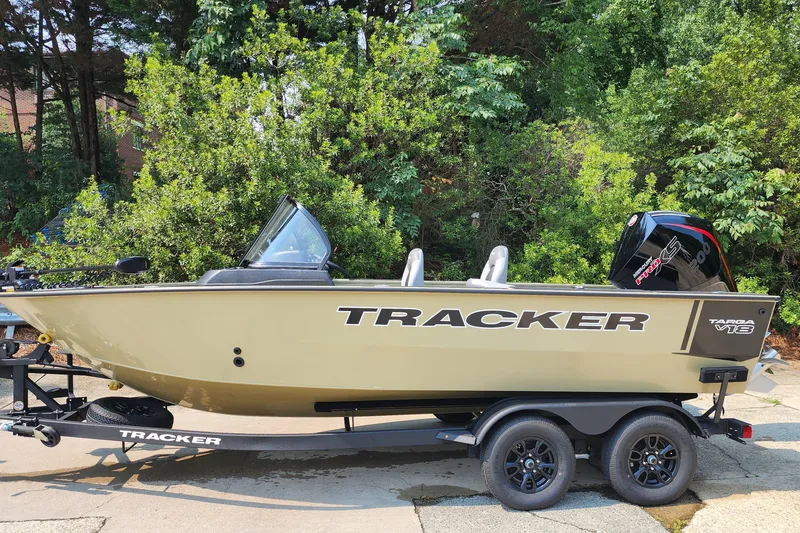 The Image of 2027 Tracker Targa V-18 Combo boat on trailer, surrounded by lush greenery. - 0