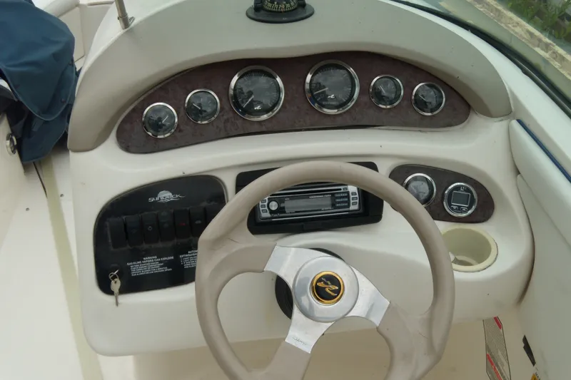 Slide: The Image of Dashboard of a 1998 Sea Ray 210 Sundeck boat with steering wheel and gauges. - 3