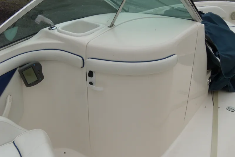Slide: The Image of 1998 Sea Ray 210 Sundeck interior with white seating and dashboard details. - 6