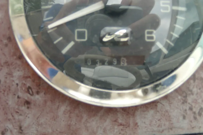Slide: The Image of Close-up of a Sea Ray 210 Sundeck 1998 boat gauge showing 3299 hours. - 12