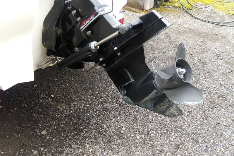 Slide: The Image of Outboard motor of a 1998 Sea Ray 210 Sundeck on gravel surface. - 2