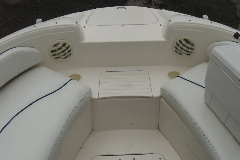 Slide: The Image of Interior of a 1998 Sea Ray 210 Sundeck boat with white seating and speakers. - 9