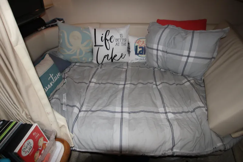Slide: The Image of Cozy cabin bed in 2000 Sea Ray 310 Sundancer with decorative pillows. - 22