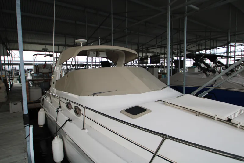 Slide: The Image of 2000 Sea Ray 310 Sundancer docked in a covered marina. - 8