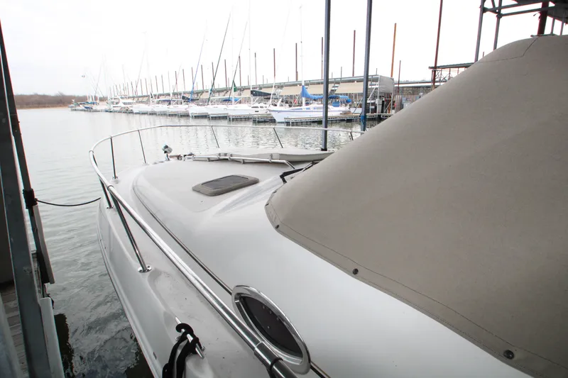 Slide: The Image of Sea Ray 310 Sundancer 2000 docked at marina with sailboats in background. - 9