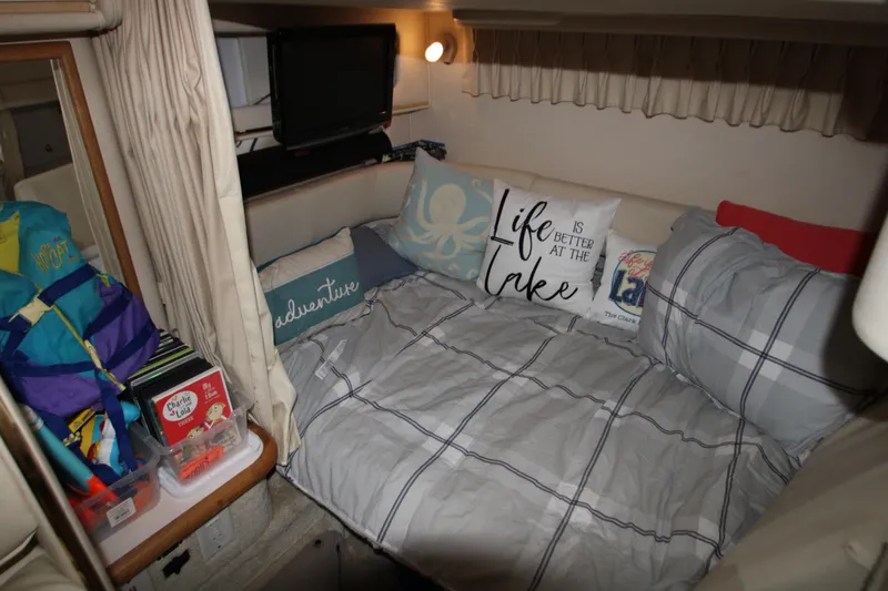 Slide: The Image of Cozy cabin interior of 2000 Sea Ray 310 Sundancer with bed and decorative pillows. - 20