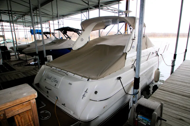 Slide: The Image of 2000 Sea Ray 310 Sundancer docked under a covered marina. - 4