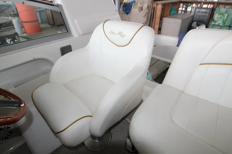Slide: The Image of White leather seats on a 2000 Sea Ray 310 Sundancer boat. - 12