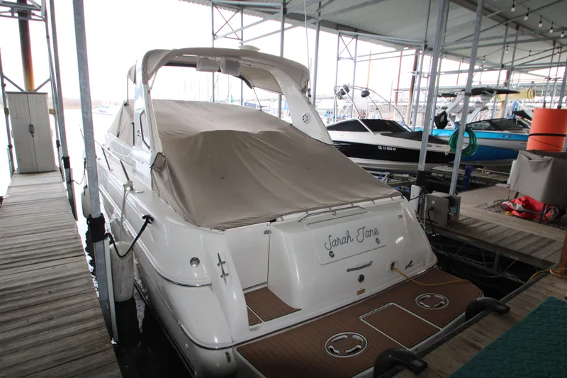 Slide: The Image of 2000 Sea Ray 310 Sundancer docked under a covered marina. - 5