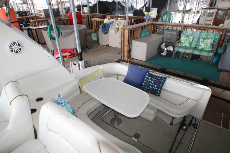 Slide: The Image of 2000 Sea Ray 310 Sundancer boat interior with white seating and table. - 3
