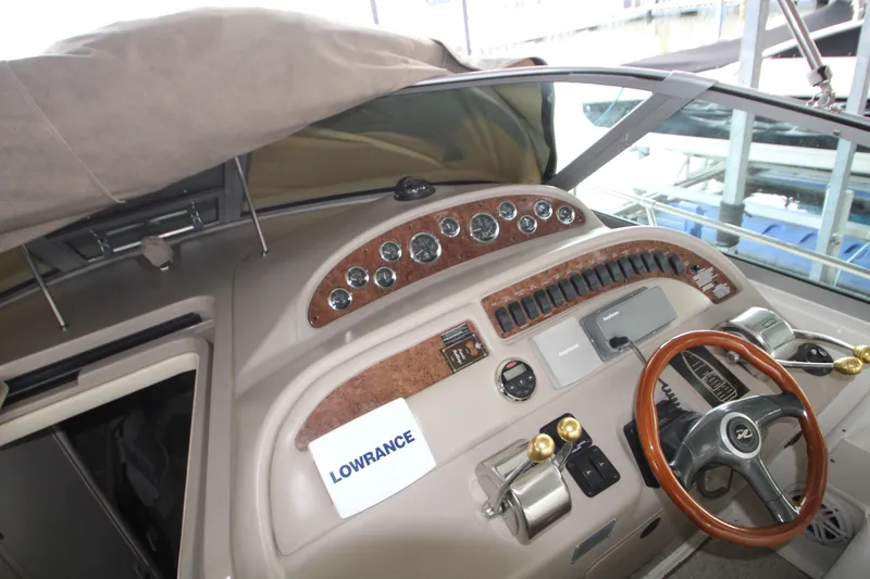 Slide: The Image of Cockpit of 2000 Sea Ray 310 Sundancer with Lowrance navigation system and wood-trimmed steering wheel. - 15