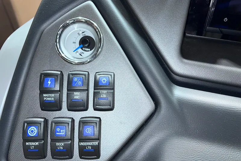 Slide: The Image of Control panel of 2026 Sylvan L3 LZ DH boat with various switches and trim gauge. - 18