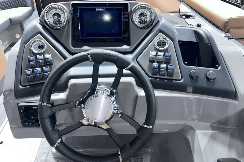 Slide: The Image of Steering console of 2026 Sylvan L3 LZ DH boat with advanced controls and Simrad display. - 16