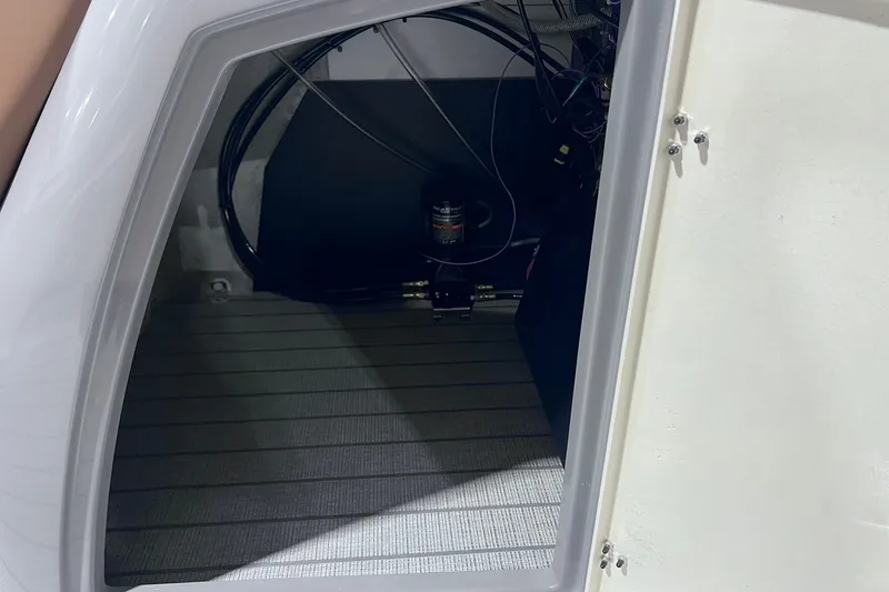 Slide: The Image of Storage compartment of 2026 Sylvan L3 LZ DH boat, featuring wiring and equipment. - 24