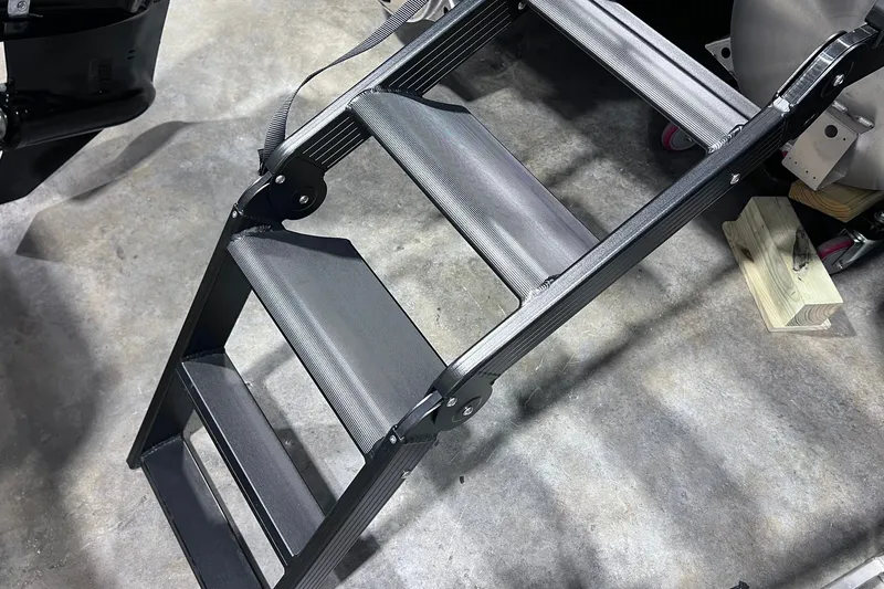 Slide: The Image of Folding boat ladder on a Sylvan L3 LZ DH, 2026 model, resting on concrete floor. - 29