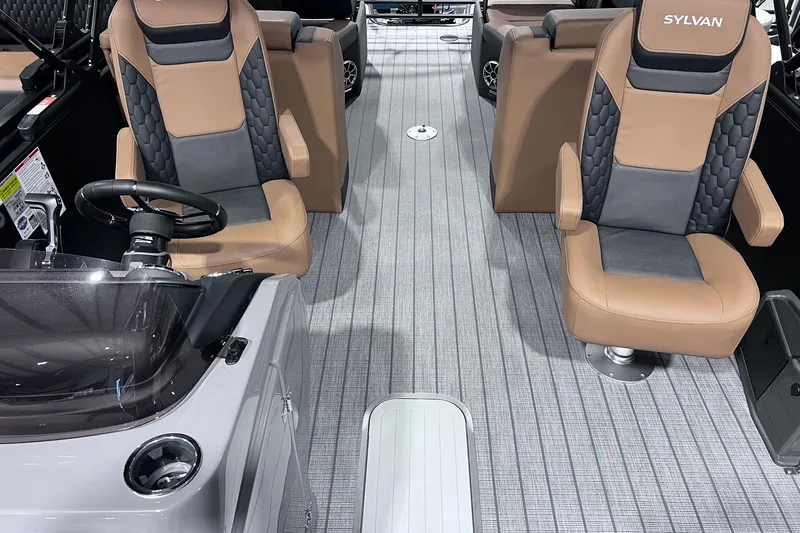 Slide: The Image of 2026 Sylvan L3 LZ DH boat interior with tan and gray seating, steering wheel, and modern design. - 4