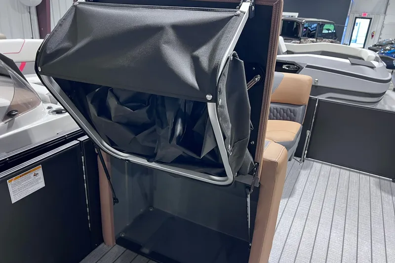 Slide: The Image of 2026 Sylvan L3 LZ DH boat interior with storage compartment and seating. - 22