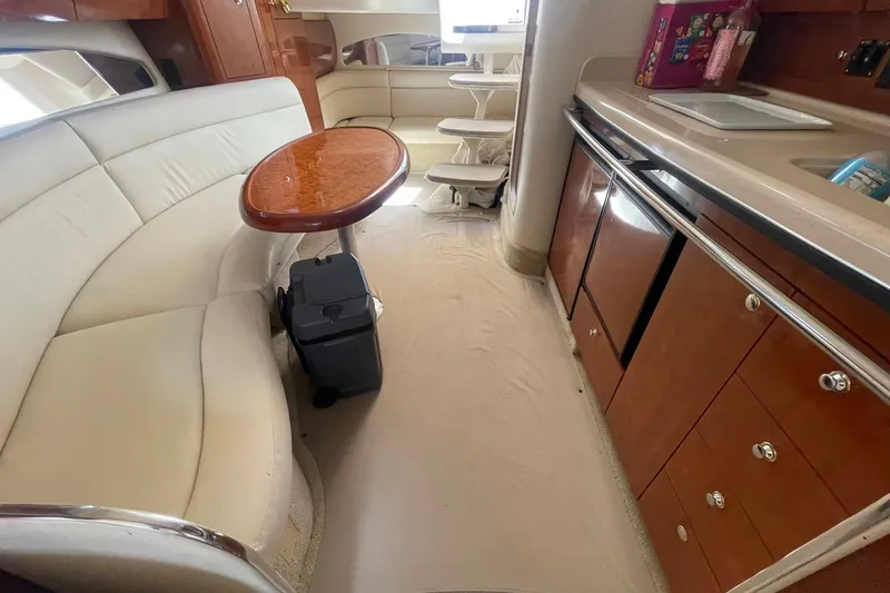 Slide: The Image of Interior of 2003 Sea Ray 360 Sundancer yacht with elegant seating and kitchenette. - 27