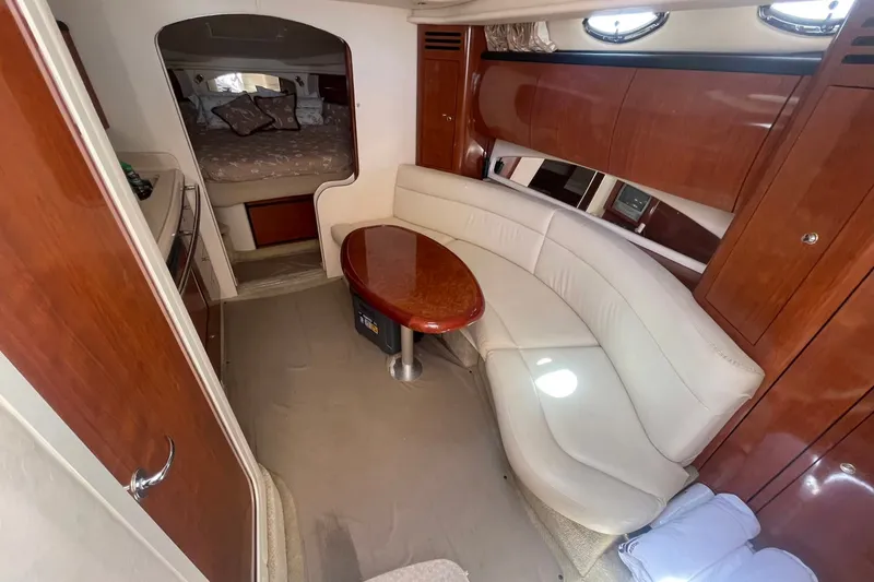 Slide: The Image of Interior of 2003 Sea Ray 360 Sundancer yacht with elegant seating and wood finishes. - 16