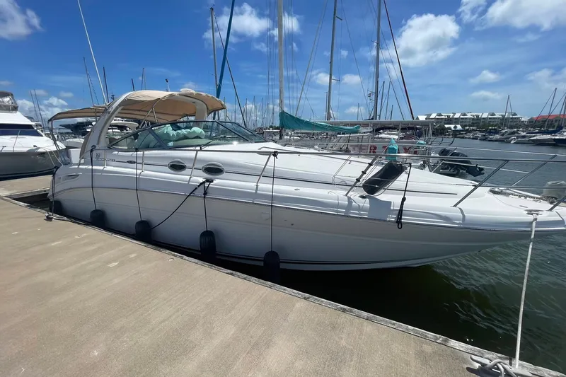 Slide: The Image of 2003 Sea Ray 360 Sundancer yacht docked at marina under clear blue sky. - 7