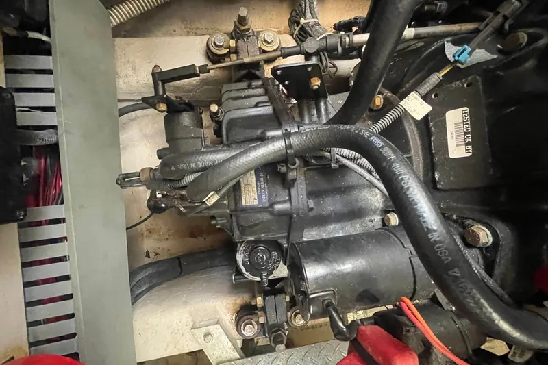 Slide: The Image of Engine compartment of a 2003 Sea Ray 360 Sundancer boat, showing mechanical components and hoses. - 39