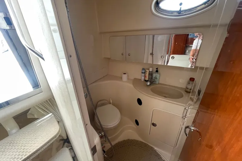 Slide: The Image of 2003 Sea Ray 360 Sundancer bathroom with sink, toilet, and mirror. - 30