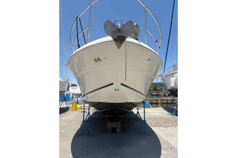Slide: The Image of 2003 Sea Ray 360 Sundancer yacht on stands, viewed from the front in a boatyard. - 3