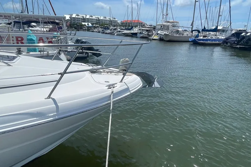 Slide: The Image of 2003 Sea Ray 360 Sundancer yacht docked in a marina under a clear blue sky. - 33